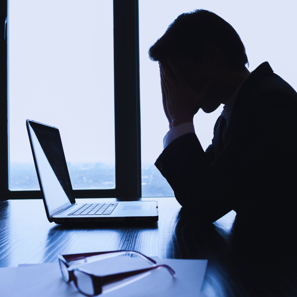 Frustrated business person looking at laptop